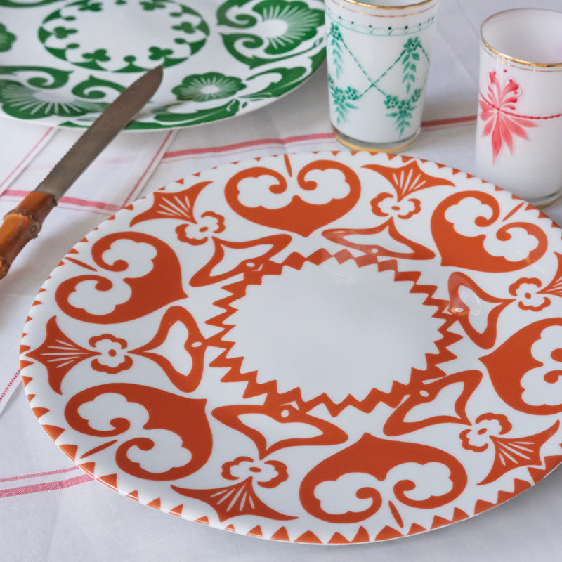 Grande assiette blanche avec motif orange, sur une table